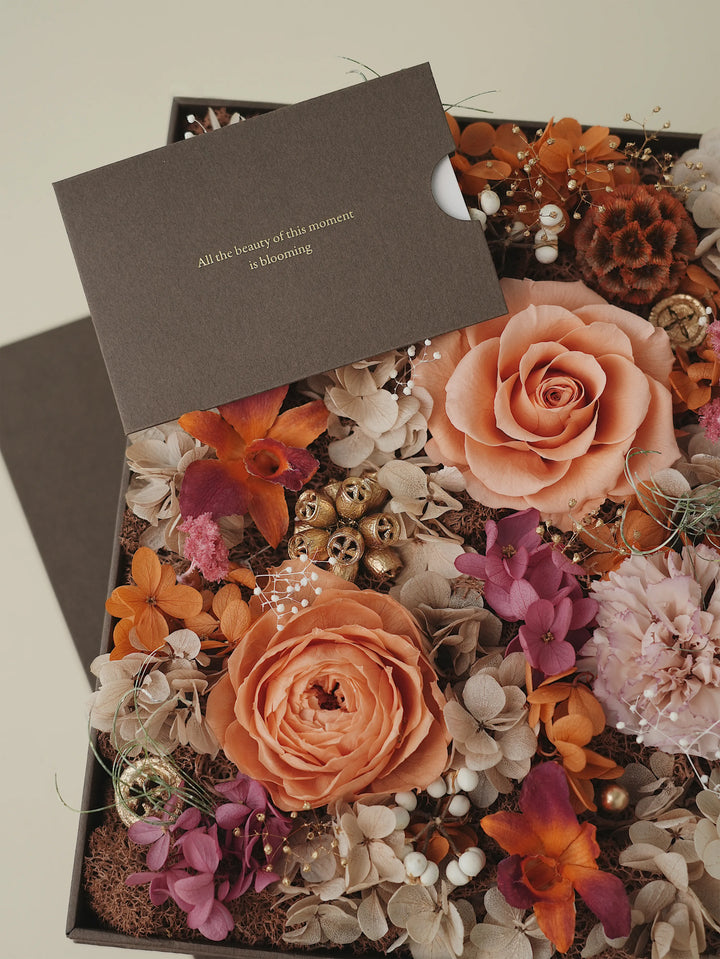 Close-up of autumn-inspired preserved florals in earthy taupe and orange hues