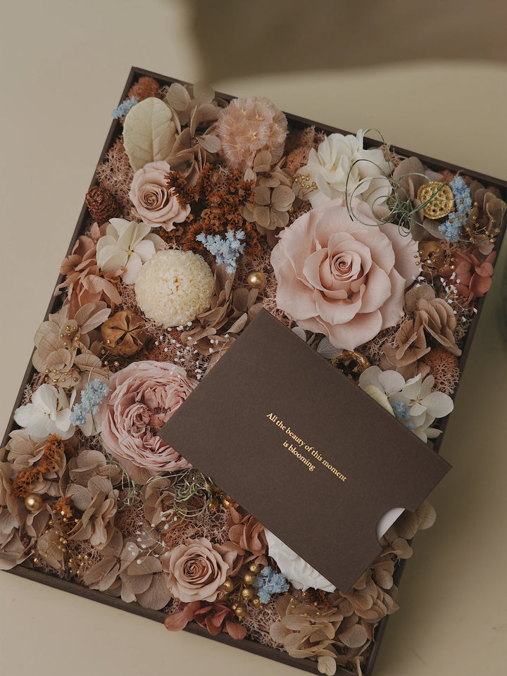 Close-up of neutral preserved roses and soft earthy florals in mocha and brown