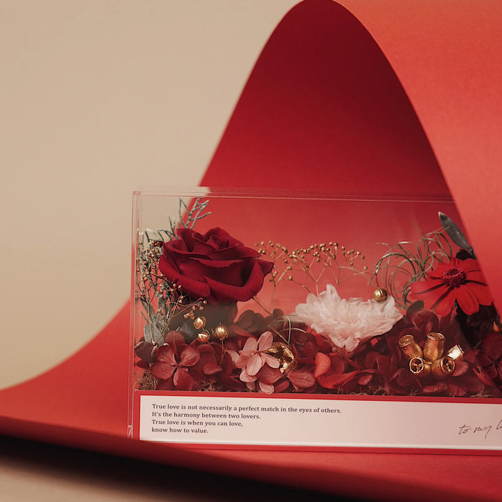 Everlasting Flora Envelope with red preserved flowers inside a clear acrylic box and red envelope base