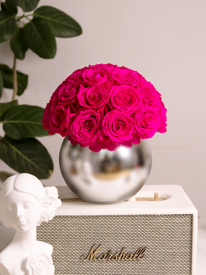 Home decor with everlasting roses and silver vase