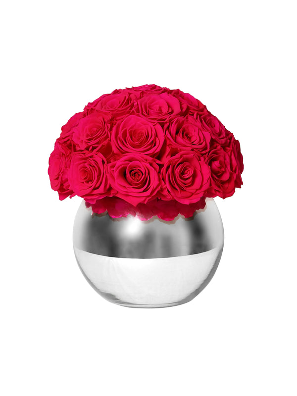 Preserved hot pink roses in silver mirror vase