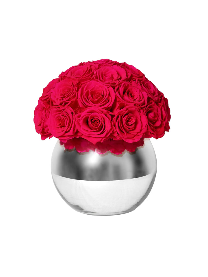 Preserved hot pink roses in silver mirror vase