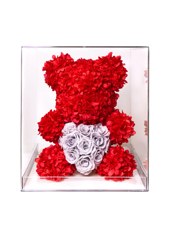 Red floral teddy bear with heart-shaped preserved roses in transparent acrylic box