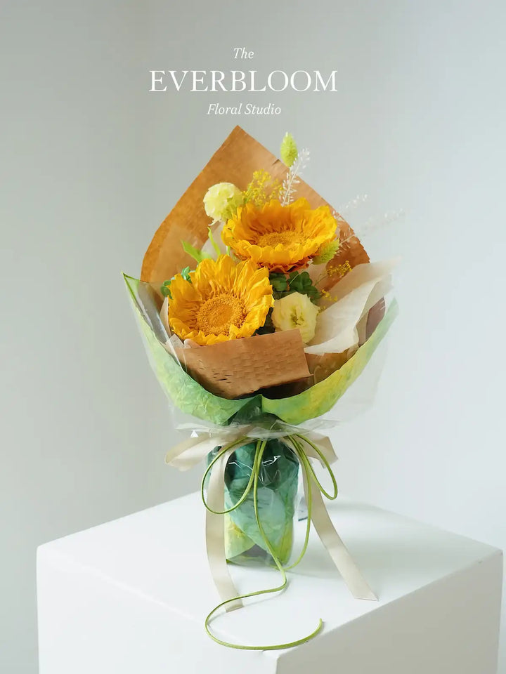 Warm yellow everlasting flowers in a delicate bouquet arrangement