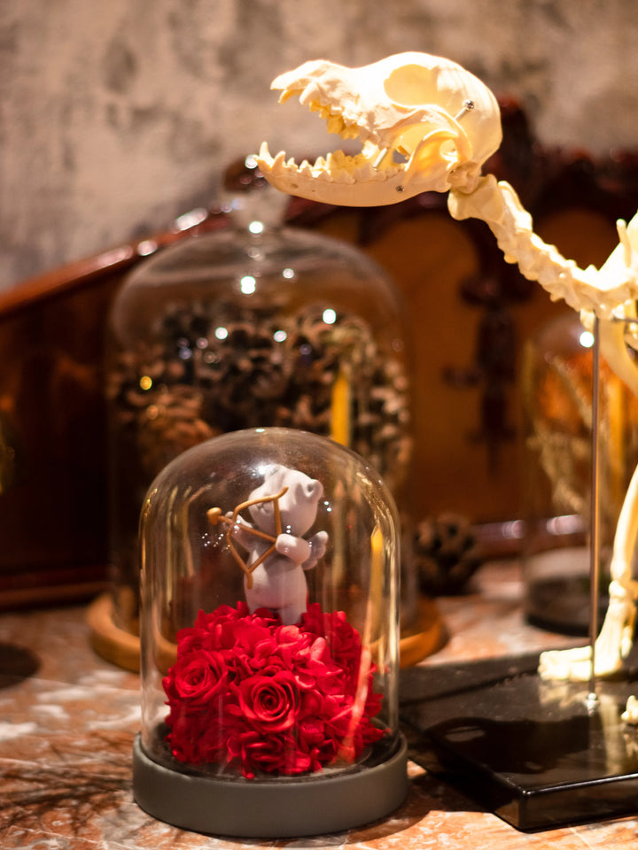 Romantic room décor featuring preserved flower dome with Cupid figure