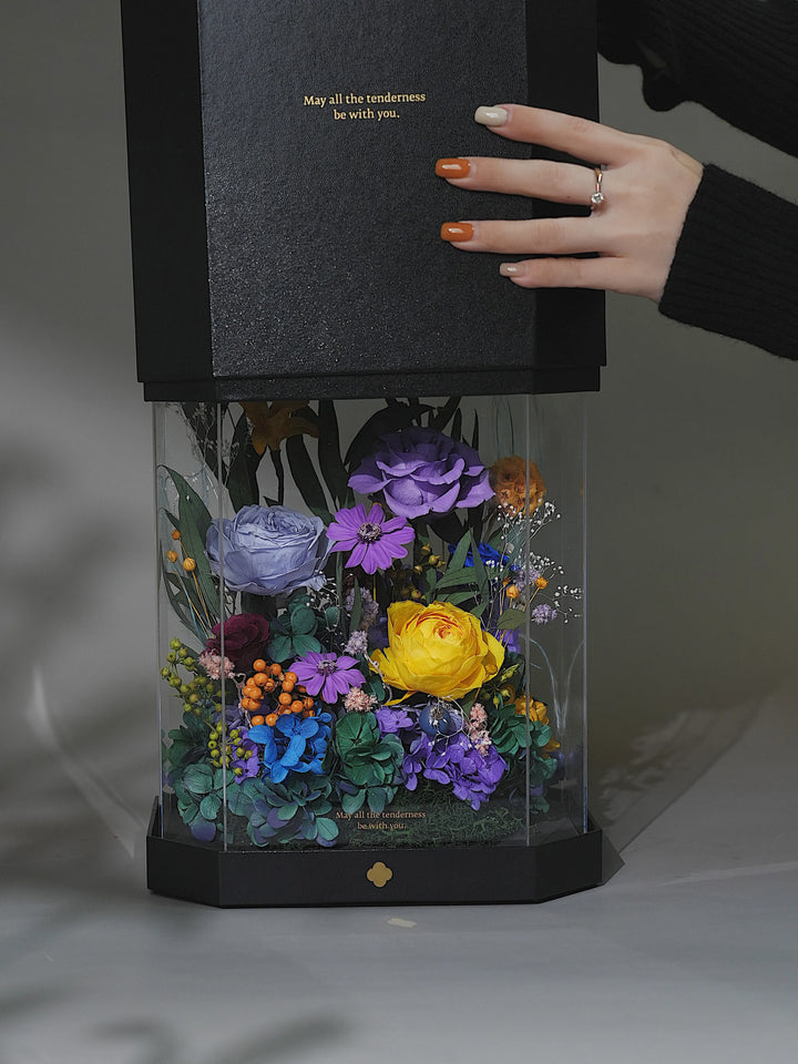 Person lifting the lid of a tall octagon preserved flower box in Monet’s Bloom Purple and Yellow