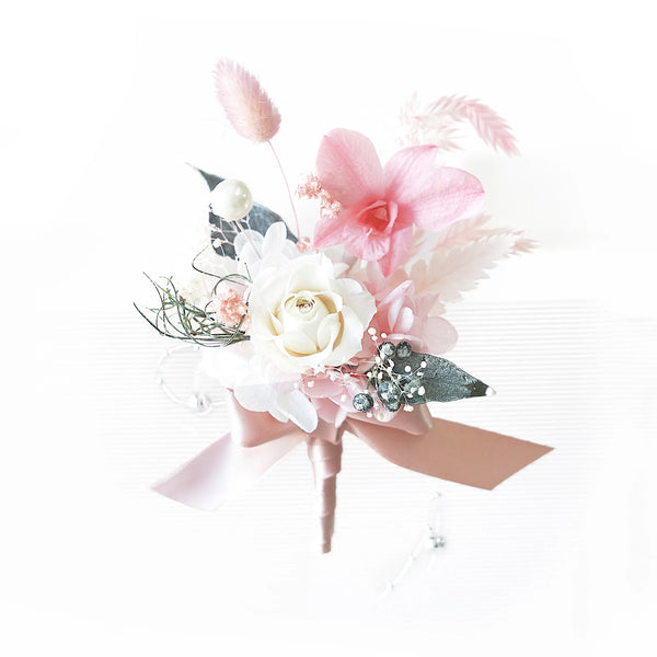Groom’s boutonniere with preserved white rose and pink orchid for formal wedding attire