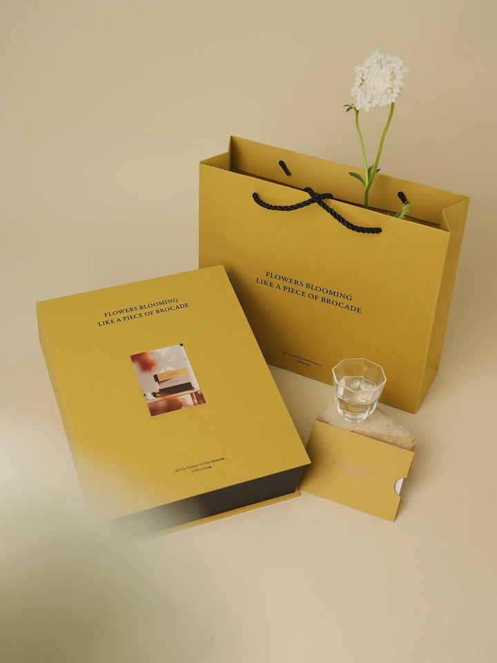 Book-style floral box in yellow with gift card and matching lid
